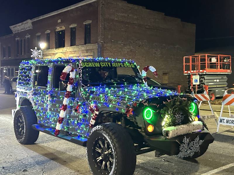 A Jeep travels down Wesley Ave. in the lighted parade during Mt. Morris' Christmas in the Village on Saturday, Dec. 7, 2024.