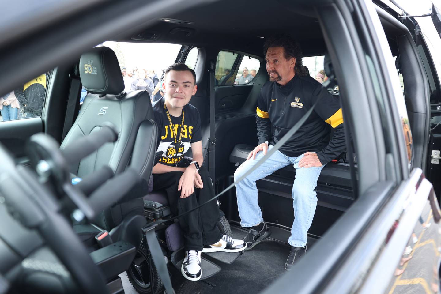 Lawson Sizemore, left, sits with Jeff Peterson in his new adaptable van at his former high school Joliet West on Tuesday, April 25, 2023 in Joliet.