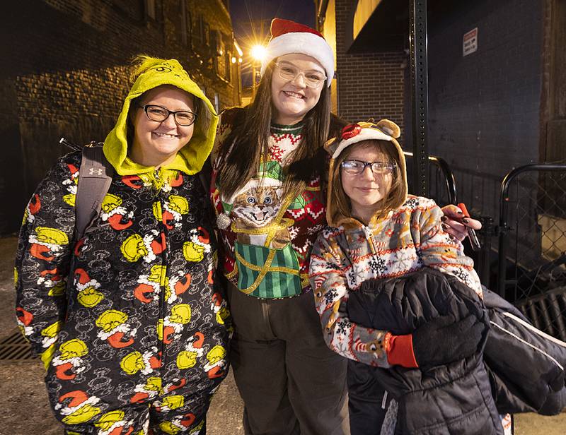Donned in their finest Christmas garb, Savannah Kopek (left), Stephanie Binkley and Emmilia Kopek check out the scene Friday, Dec. 6, 2024, in Dixon.