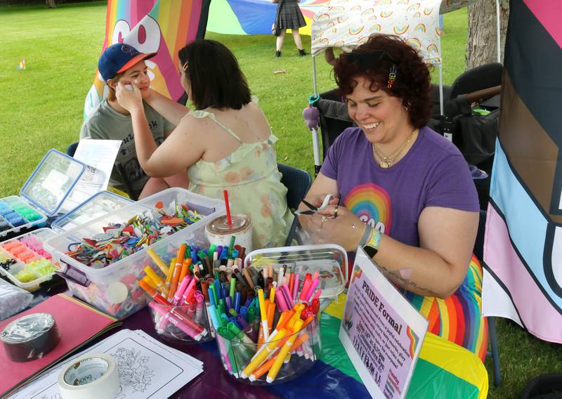 Rowan Ellis, (left) from Genoa, Hope Johnson, from DeKalb, and Bridget Johnson, (right) from DeKalb, enjoy the craft table during the Pride Palooza Friday, May 30, 2025, at Bethlehem Lutheran Church in DeKalb. The event was hosted by Family Service Agency of DeKalb County and Youth Outlook.