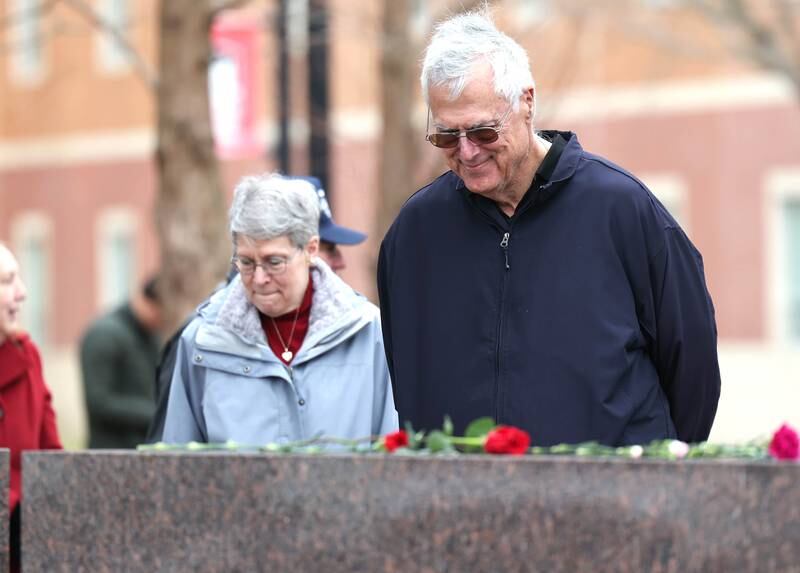 Linda Greer, mother of shooting victim Dan Parmenter, and her husband Robert Greer pay their respects during a remembrance ceremony Tuesday, Feb. 14, 2023, at the memorial outside Cole Hall at Northern Illinois University for the victims of the mass shooting in 2008. Tuesday marked the 15th year since the deadly shooting took place on campus which took the lives of five people.