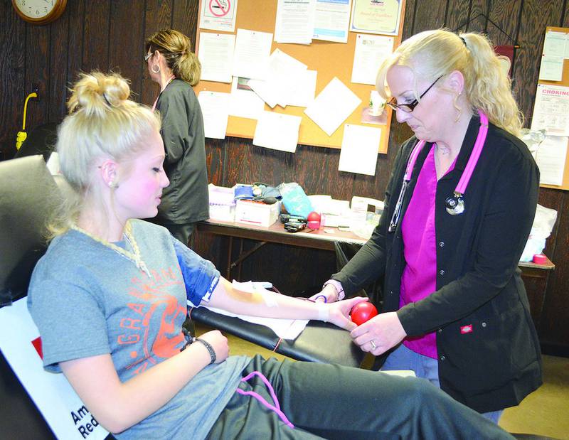 Grace Risatti of Buda donates her blood, while Val Kramer prepares for oversees the procedure. Two were at the American Red Cross blood drive, held Friday at the Tiskilwa Fire Department.