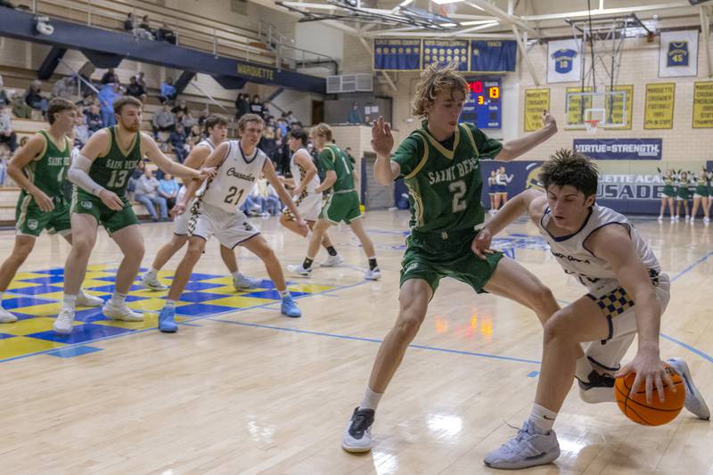 St. Bede's Kaden Nauman defends the basket against an attack from a Marquette athlete during the game on January 10, 2025 at Marquette Academy.