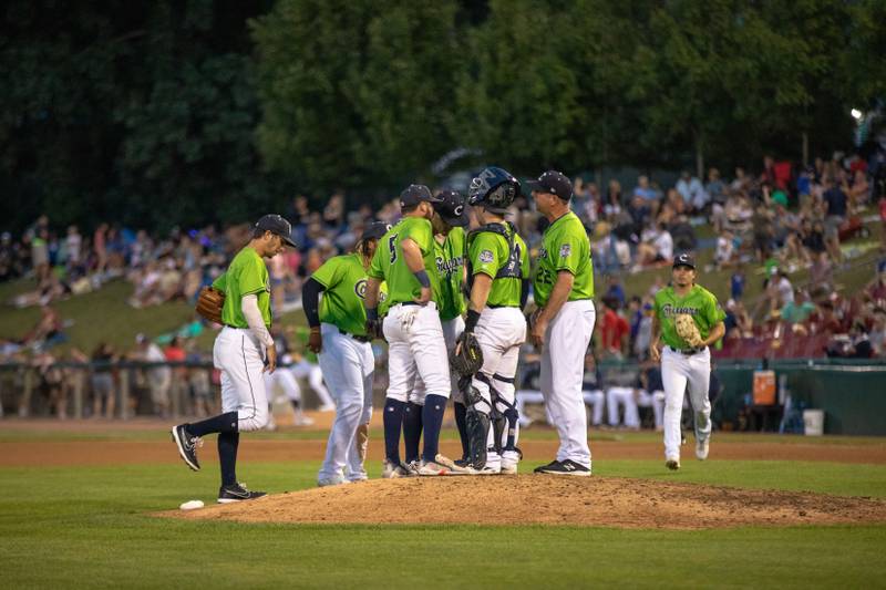 The Kane County Cougars meet at the pitching mound during a game against the Milwaukee Milkmen at Northwestern Medicine Field on Thursday, July 14, 2022.