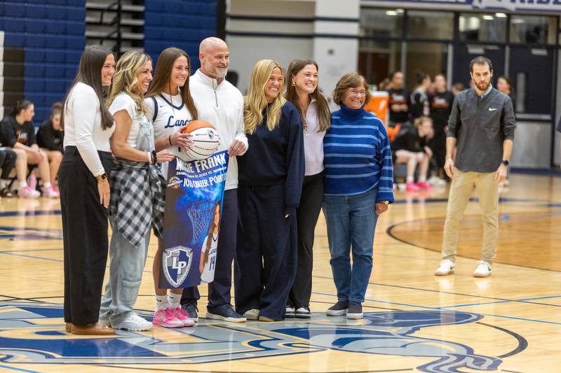 Lake Park's Maggie Frank is honored before the game for scoring 1,000 points with her family on Wednesday, Jan. 7,2026 in Roselle.