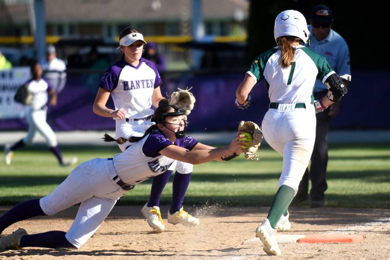 Manteno's Maddy Delya, left, dives in attempt to tag Coal City's Rese Symons out at first base during the Class 2A Manteno Regional semifinals Wednesday, May 20, 2026.