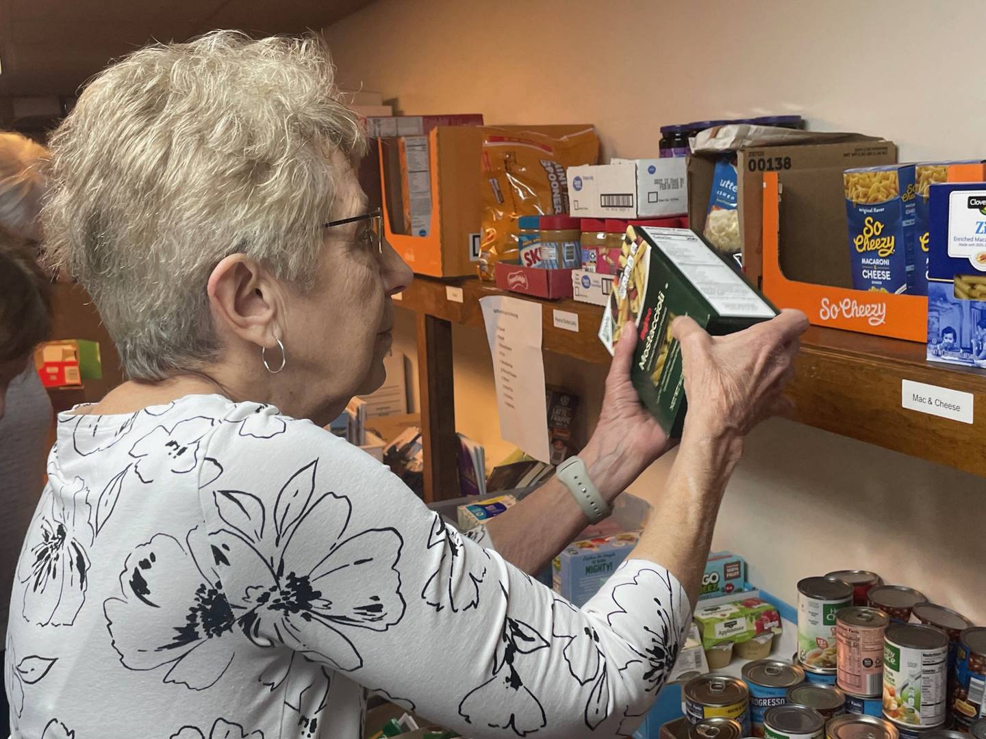Kathy Rauh sorts donations of non-perishable foods at St. Patrick's Catholic Church in La Salle. Rauh and a small group of volunteers can issue limited food assistance, but that can fill a critical gap in between distributions by the local food pantries.