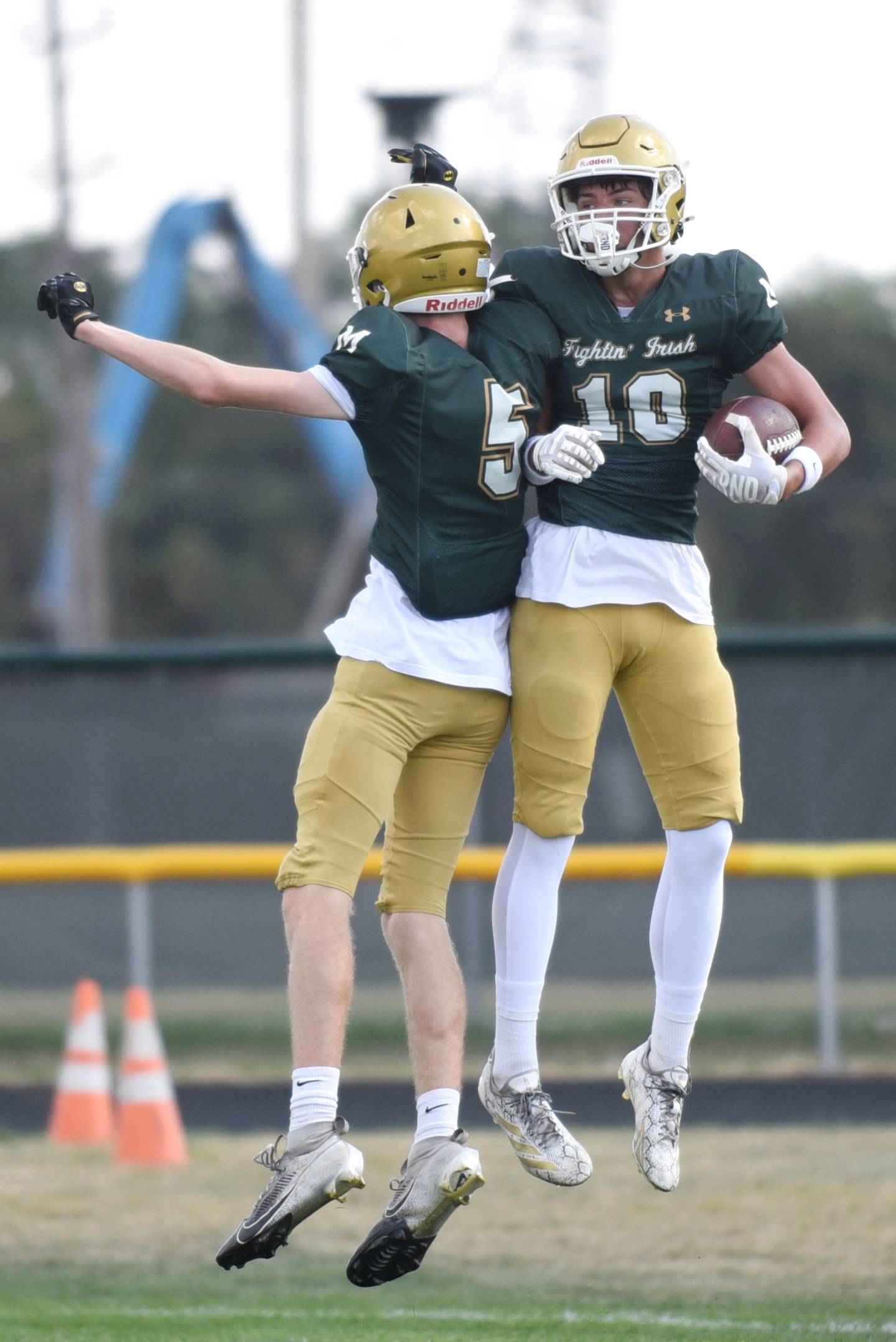 Bishop McNamara's Coen Demack, right, is congratulated by teammate Richie Darr after scoring a touchdown during a home game against Marian Central Saturday, Oct. 4, 2025.