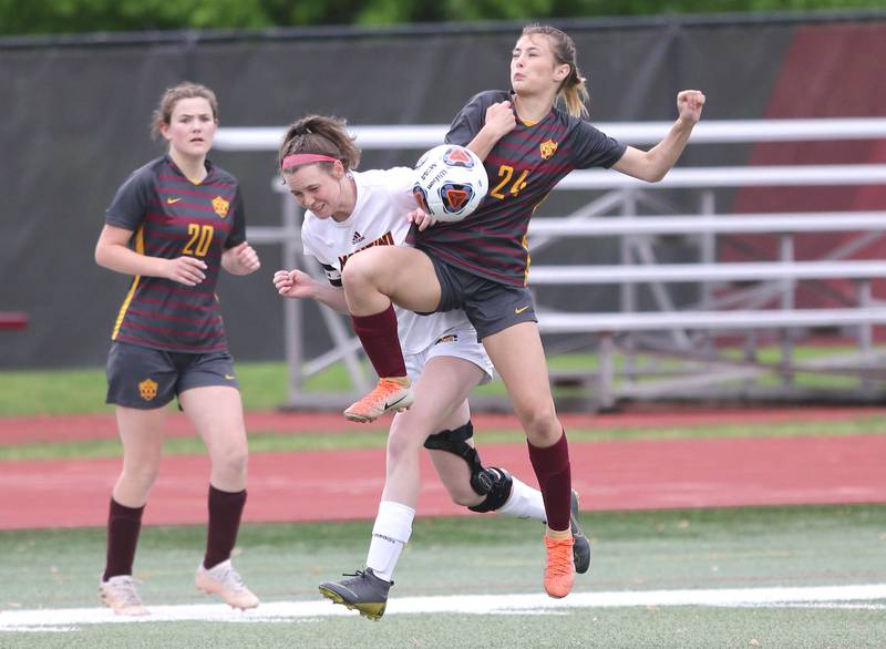 Montini's Maren Hoovel (left) and Richmond-Burton's Ember Demers try to win possession Friday, May 27, 2022, during their IHSA Class 1A state semifinal game at North Central College in Naperville.