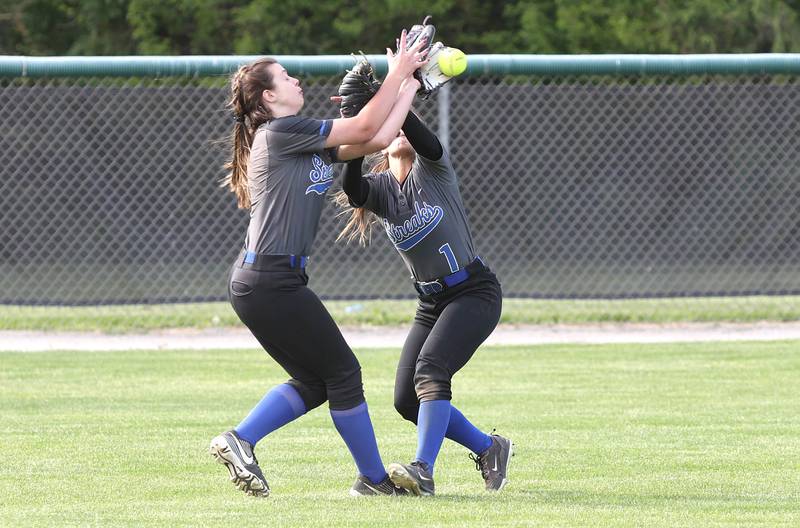Woodstock's Maddie Graunke (left) and Abby Weber collide while chasing a fly ball during their Class 3A Regional game against Kaneland Tuesday, May 24, 2022, at Kaneland High School in Maple Park.