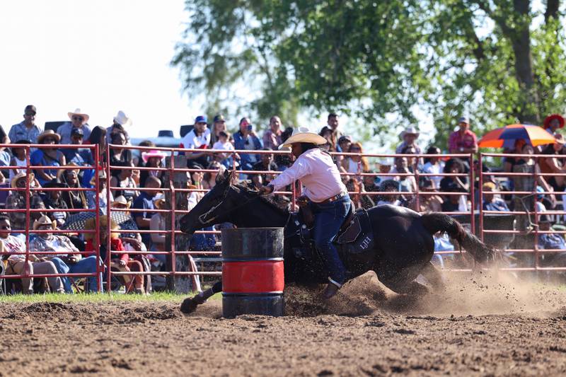 LeAndrea Hill, of St. Anne, makes the turn around a barrel as the crowd watches during the 50th Pembroke Rodeo on Sunday, May 24, 2026.