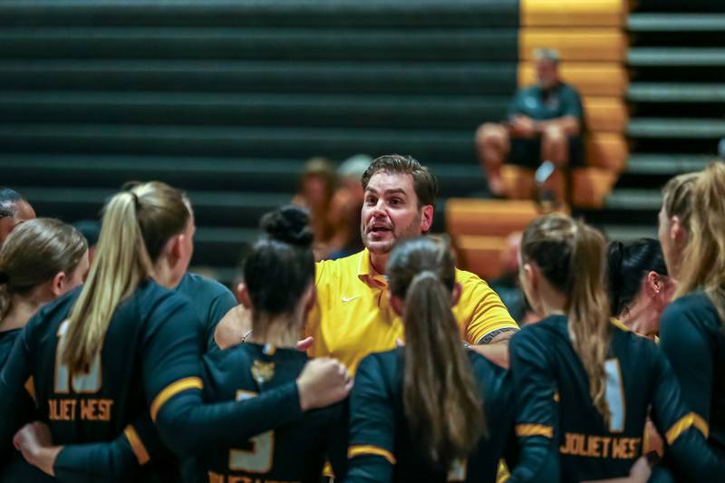 Joliet West's head coach Christopher Lincoln instructs the team during a timeout in their regional final volleyball match versus Bolingbrook.  Oct 26, 2023.