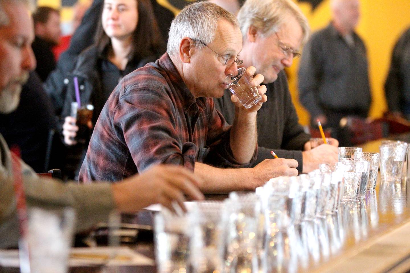 Dan Mann, retired from the Village of South Elgin, tastes water from various villages and cities throughout Kane County during the annual Kane County Water Association Water Taste Test at Global Brew in St. Charles on Thursday, Dec. 15, 2022.