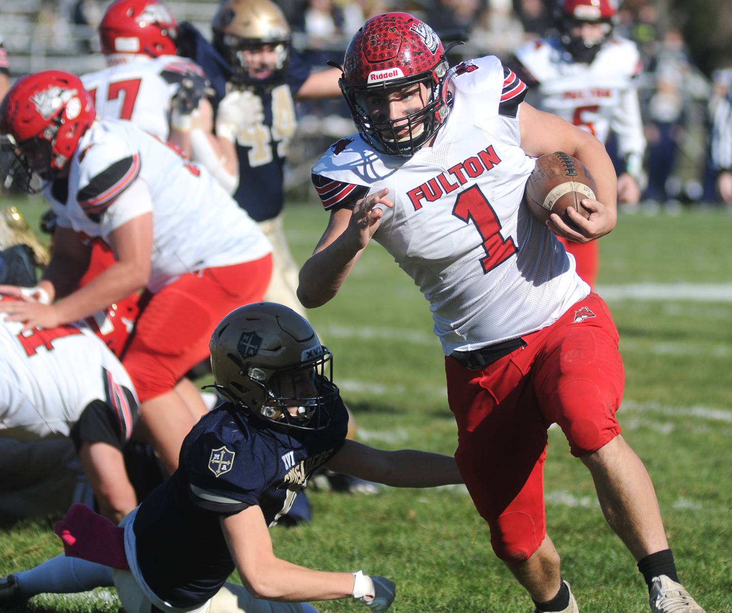 Fulton's Keegan Vankampen (1) dodges the Crusader defense as he runs 28 yards for the first touchdown of the game at Gould Stadium on Saturday, Nov. 6, 2021.