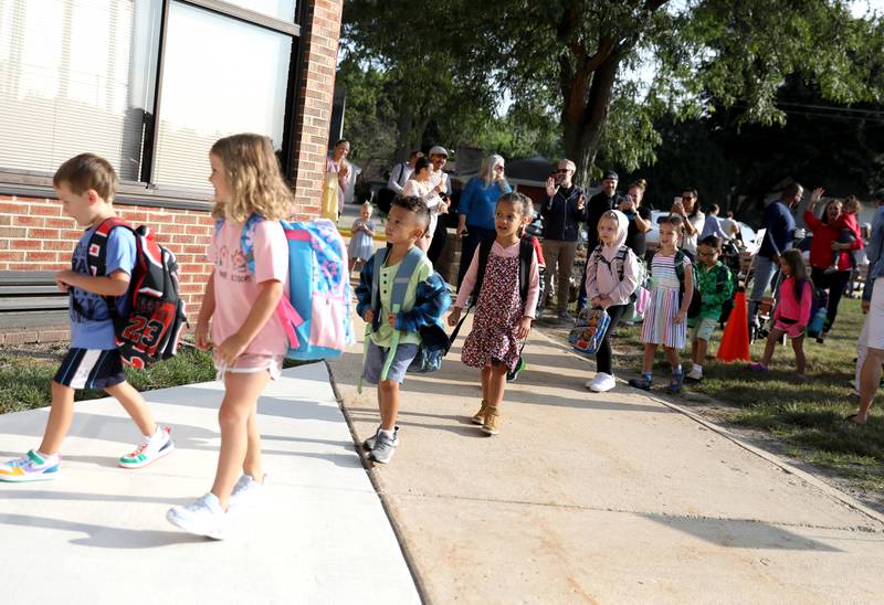 Students enter the school on the first day Thursday, Aug. 22, 2024 at Harrison Street Elementary School in Geneva.