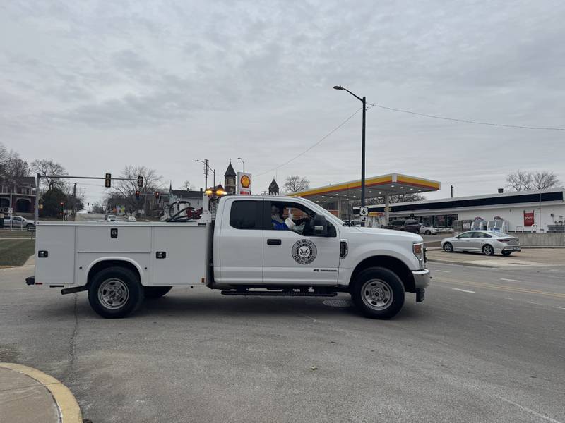 Officer Santa waves on his way to deliver gifts to more than 100 kids on Saturday. December 14, 2024.