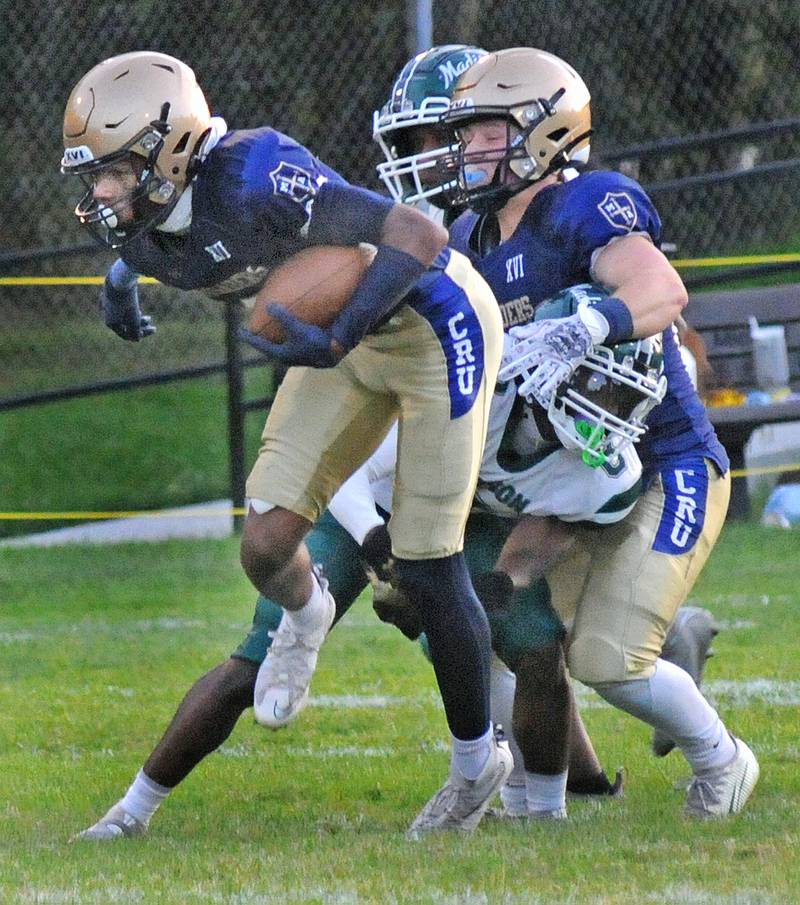 Marquette’s Connor Baker breaks away from a Madison tackle in the 1st quarter Friday at Marquette.