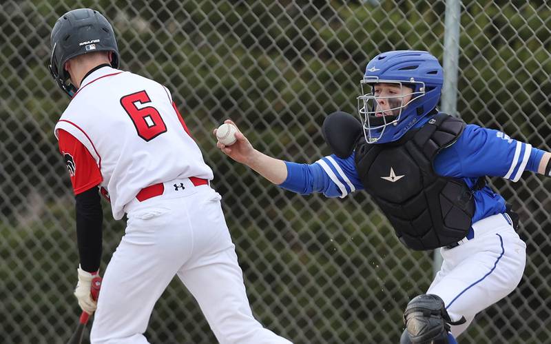 Hinckley-Big Rock's Joe Bazan tries to tag out Indian Creek's Giovanni Data after a dropped third strike during their game Monday, May 1, 2023, at Indian Creek High School in Shabbona.