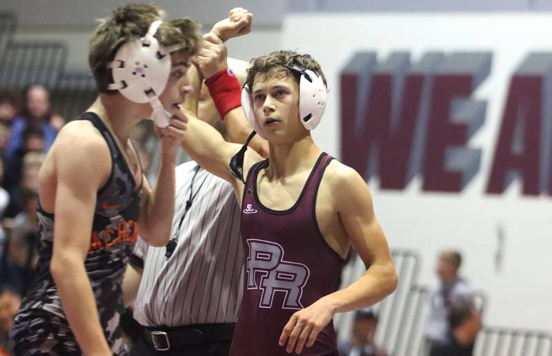 Prairie Ridge’s Tymen Robinson is declared the winner over McHenry’s Max Ersler at 106 pounds in varsity boys wrestling on Thursday, Jan. 8, 2026 at Prairie Ridge High School in Crystal Lake.