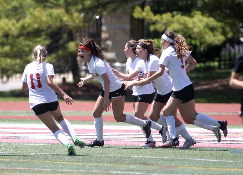 Deerfield players celebrate Emily Fox’s (8) goal during an IHSA Class 2A state semifinal game against Benet at North Central College in Naperville on Friday, June 3, 2022.