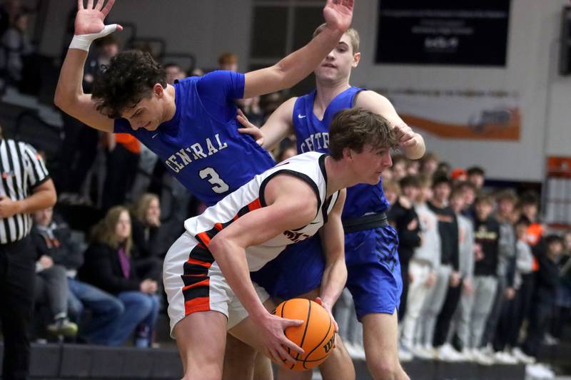 Burlington Central’s Lucas Kerr, top, guards McHenry’s Dylan Hurckes in varsity boys basketball on Tuesday, Feb. 4, 2025, at  McHenry High School  in McHenry.