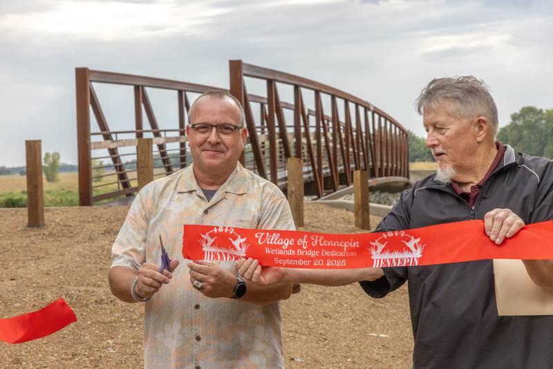 Hennepin Mayor Quentin J. Buffington cuts the ceremonial ribbon to mark the opening of the Kevin Coleman Bridge connection Hennepin to Sue and Wes Dixon Wildlife refuge at 501 3rd Street on September 20, 2025 in Hennepin.