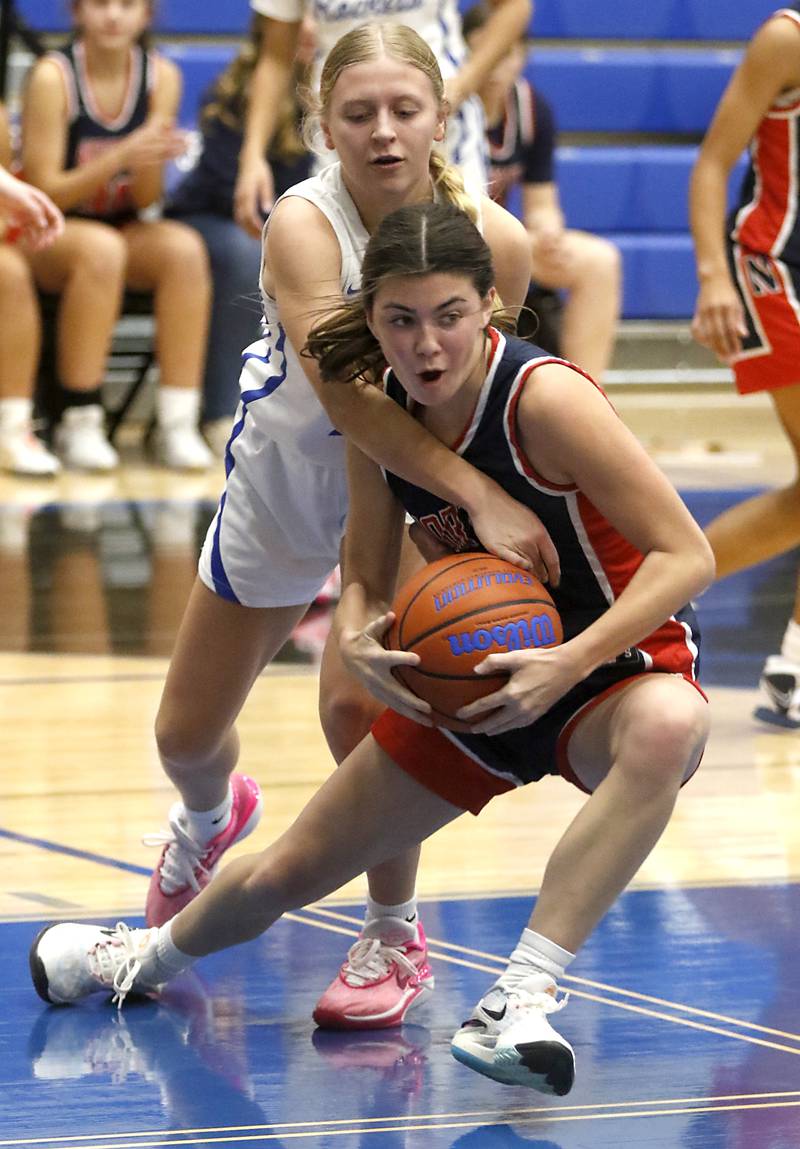 Burlington Central's Ashley Waslo tries to steal the ball from Belvidere North's Ava Armstrong on Monday, Nov. 13, 2023, during pool play girls basketball game in the Burlington Central Mark Einwich Tournament.