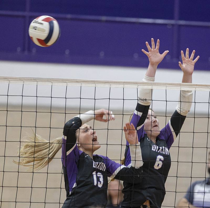 Dixon’s Solis Thompson (left) and Rayven Mowery go up for a block against Rock FallsThursday, Sept. 18, 2025.