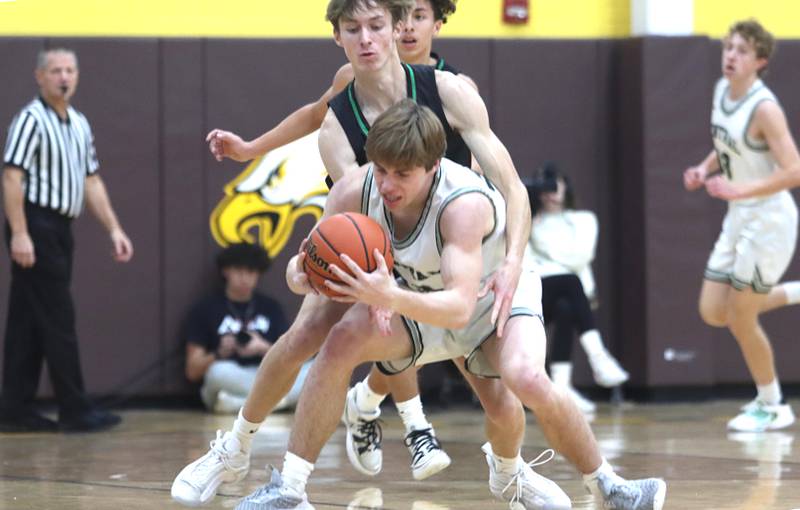 Crystal Lake South’s James Carlson, back, covers Grayslake Central’s Jake Kruse, front, during Hinkle Holiday Classic Basketball Tournament title game action at Jacobs High School Friday.