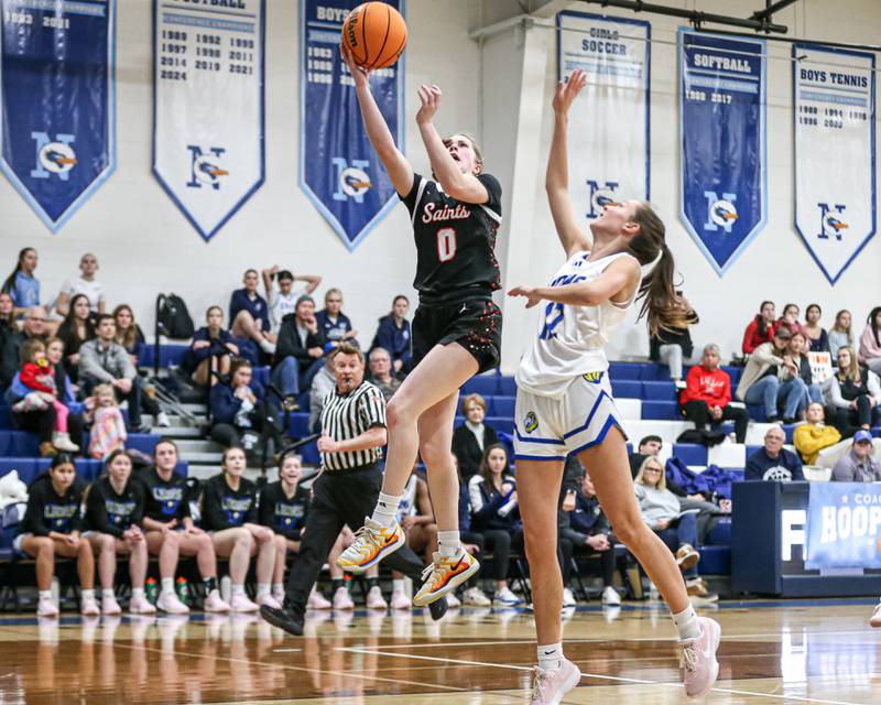 Saint Charles East's Kathlyn Bainbridge (0) puts in a layup during their Coach Kipp's Hoopfest basketball game between Lyons at St Charles East. Jan 18, 2025 in La Grange.