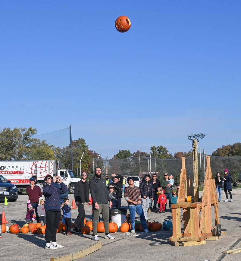 A Halloween pumpkin is catapulted into a composting container at a past "Pumpkin Catapult" at Lewis University in Romeoville. Oct. 31, 2024