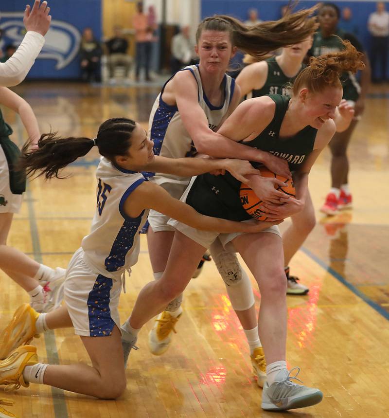 Johnsburg's Kailey Delulio (left) and Skye Toussaint (center) tries to take the ball from St. Edward's Layne Dawson (right) during the IHSA Class 2A Johnsburg Sectional girls basketball championship game on Thursday, February, 26, 2026, at Johnsburg High School.