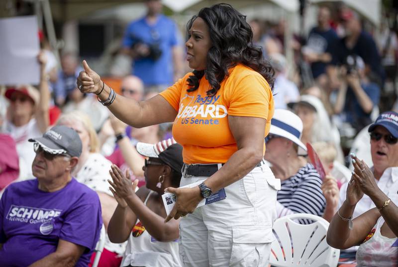 Peggy Hubbard, a Republican candidate for the U.S. Senate, gives a thumbs up as Richard Porter delivers his remarks during Republican Day at the Illinois State Fair on the Director's Lawn at the Illinois State Fairgrounds in Springfield, Ill., Thursday, Aug. 19, 2021. (Justin L. Fowler/The State Journal-Register via AP)