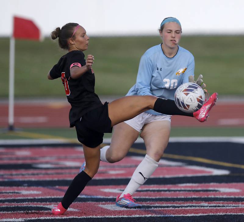 Huntley's Maddie Cummings tries to kick the ball into th goal in front of Jacobs' Addison Hunsicker during the IHSA Class 3A Huntley Girls Soccer Regional championship match on Friday, May 23, 2025, at Huntley High School.