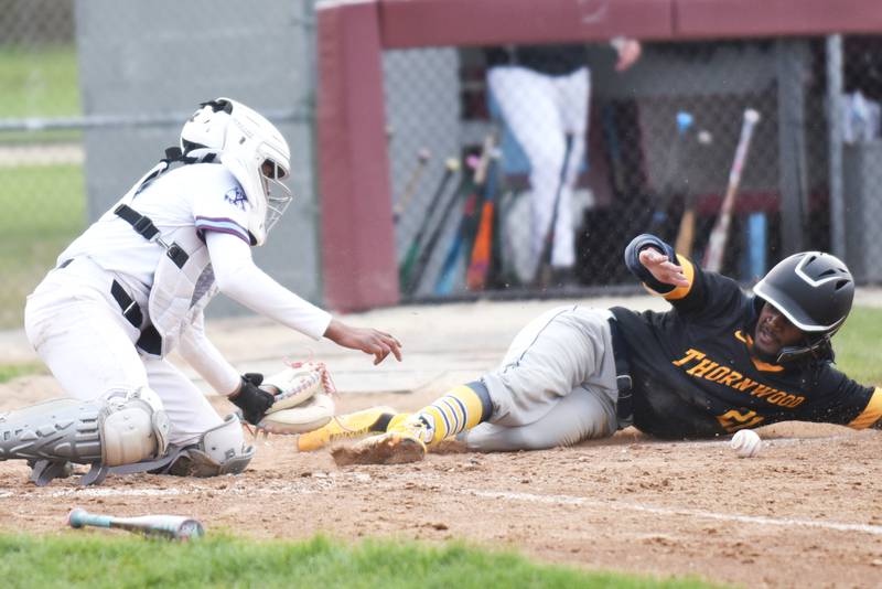 Thornwood's Jaden Lee, right, slides into home plate as Kankakee catcher Jay'den Jones fields a throw home during a game at Kankakee Thursday, April 17, 2025.