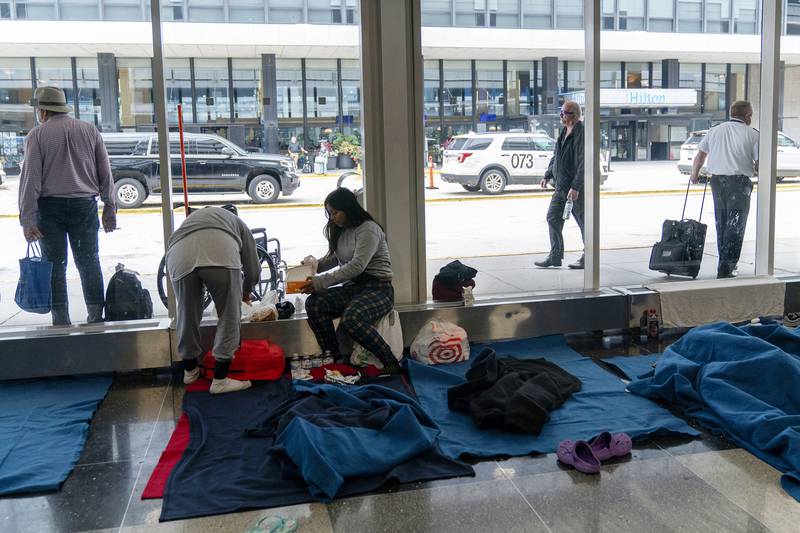 FILE - Run by a private firm hired by the city, migrants stay in a makeshift shelter at O'Hare International Airport, Sept. 20, 2023, in Chicago. Five mayors from around the U.S. want a meeting with President Joe Biden to ask for help controlling the continued arrival of large groups of migrants to their cities. The mayors of Denver, Chicago, Houston, New York and Los Angeles say in a letter to Biden that there has been little to no coordination, support or resources and that is leading to a crisis.  (AP Photo/Erin Hooley, File Photo)