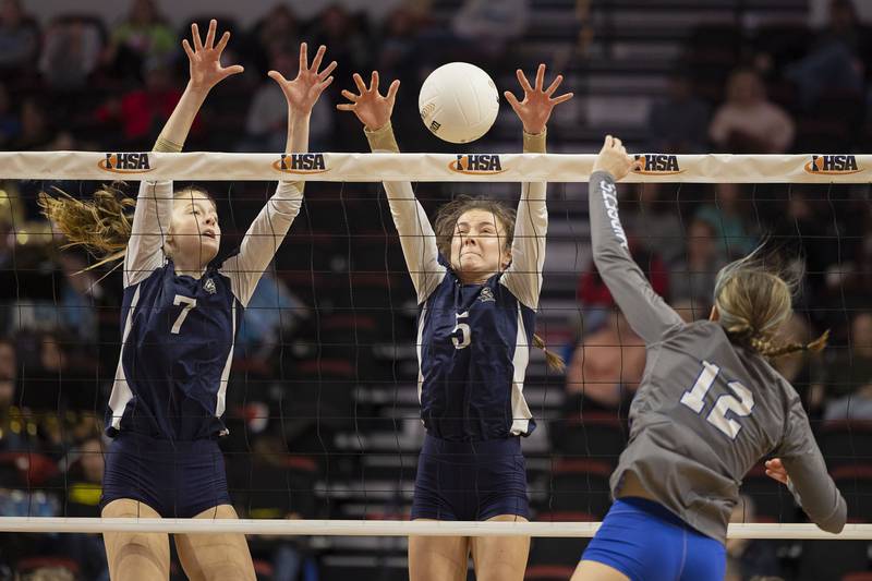 IC Catholic’s Delilah Hyland (left) and Kiely Kemph go up for a block against Freeburg’s Mia Dircks Friday, Nov. 11, 2022 during a class 2A semifinal volleyball game Friday, Nov. 11, 2022.