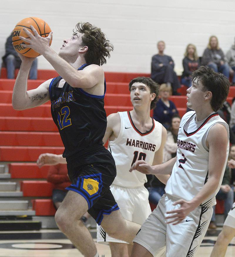 Somonauk’s Owen Hopkins gets past Woodland’s Jaron Follmer and Nolan Price to score in the 2nd period Wednesday at Woodland.