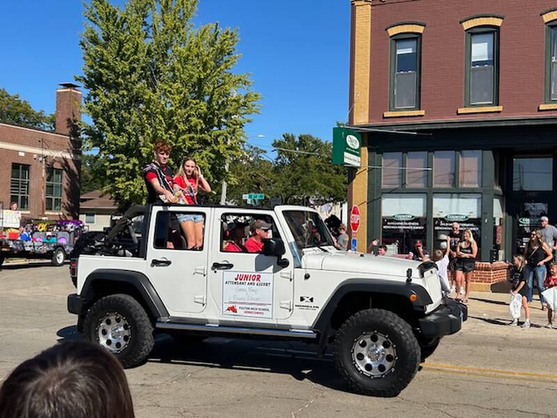 Junior attendants Grace Bray and Brody Glazier greet the crowd during Friday's Homecoming parade in Fulton.