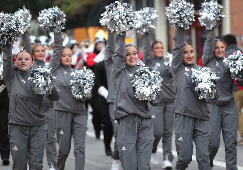 The Northern Illinois University Silverettes make their way down Lincoln Highway as they perform in the March of the Huskies parade during the NIU Huskie Homecoming Block Party Thursday, Oct. 12, 2023, in downtown DeKalb.