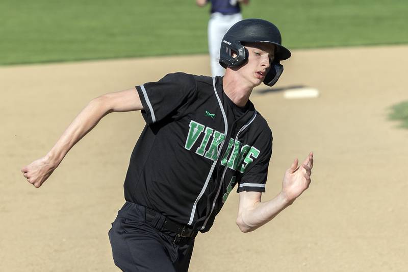 North Boone’s Brandon Slater rounds third to score against Dixon Tuesday, May 6, 2025.