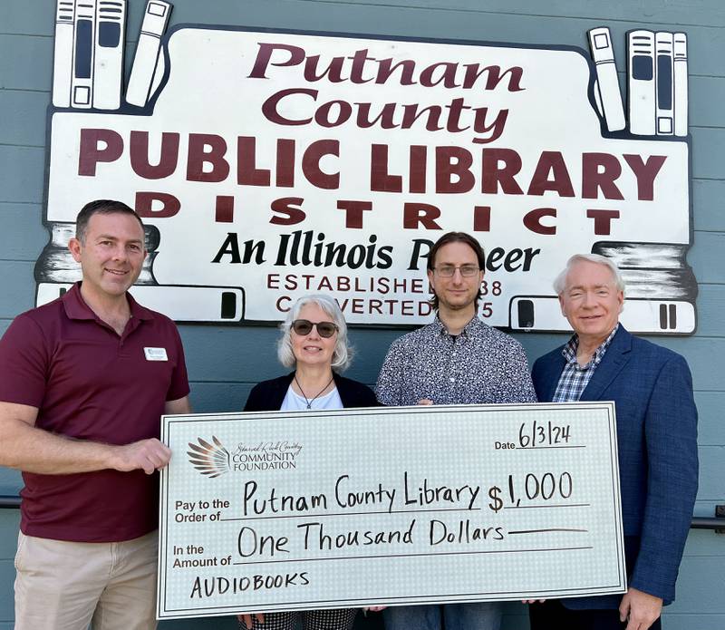(From left) Starved Rock Country Community Foundation board member, Pierre Alexander; Cheryl Young and Matt Miller, of the Putnam County Public Library; and Reed Wilson, chairman of the SRCCF board come together for a donation from SRCCF to the Putnam County Library District.