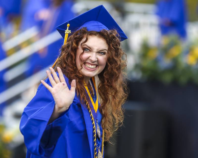 A student waves to her family at the Lyons Township High School Graduation ceremony Wednesday, May 28, 2025  in Western Springs.