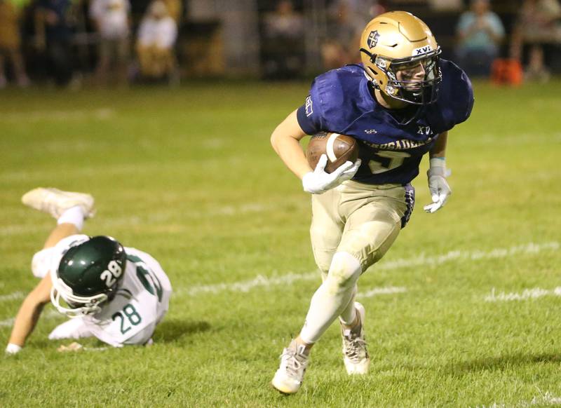 Marquette's Easton DeBernardi runs back a punt as he fakes out St. Bede's Brody Burris on Friday, Sept. 26, 2025 at Gould Stadium in Ottawa.