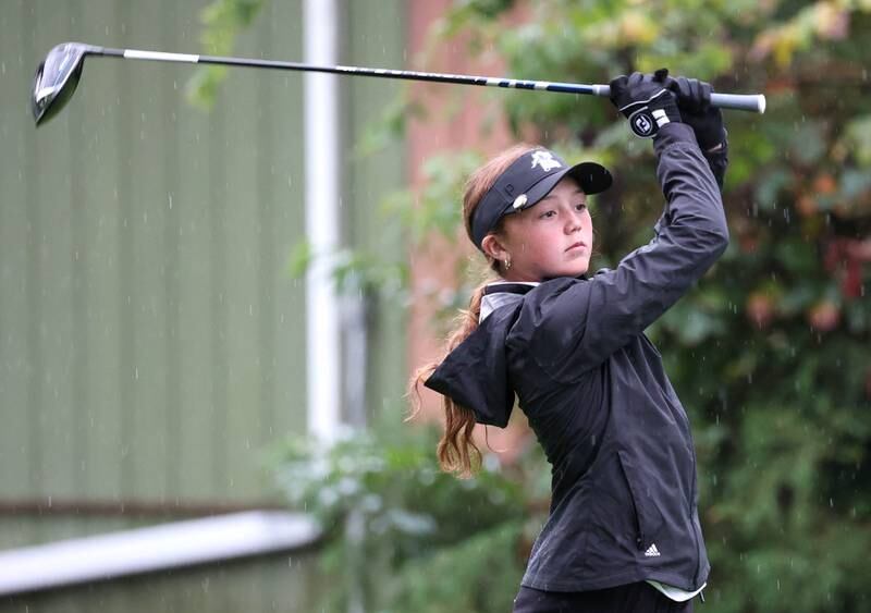 Kaneland’s Emma Kunstman watches her tee shot on the third hole Tuesday, Sept. 24, 2024, during the Interstate 8 girls golf tournament at the Sycamore Golf Club.