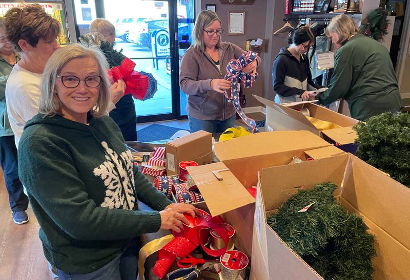 DeKalb American Legion Auxiliary members assembling veteran holiday wreaths