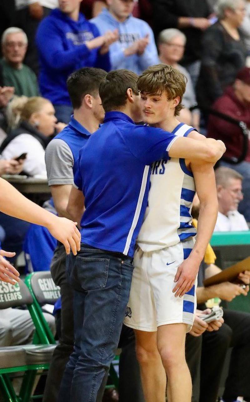 Princeton senior Teegan Davis gets a hug from his brother, Cael, a Tiger assistant, after fouling out in Friday's Class 2A Orion Sectional championship game at Geneseo.