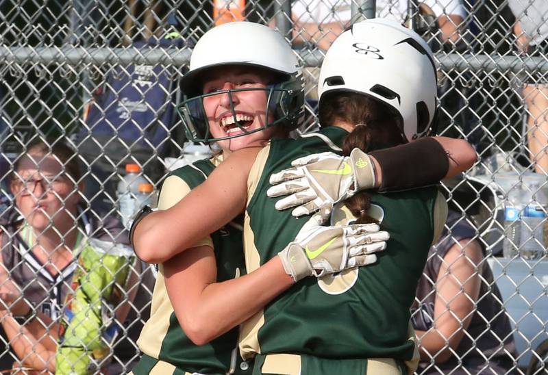 St. Bede's Emma Slingsby hugs teammate Lily Bosnich after scoring the teams second run against Ridgewood AlWood Cambridge in the Class 1A Sectional semifinal game on Tuesday, May 23, 20223 at St. Bede Academy.