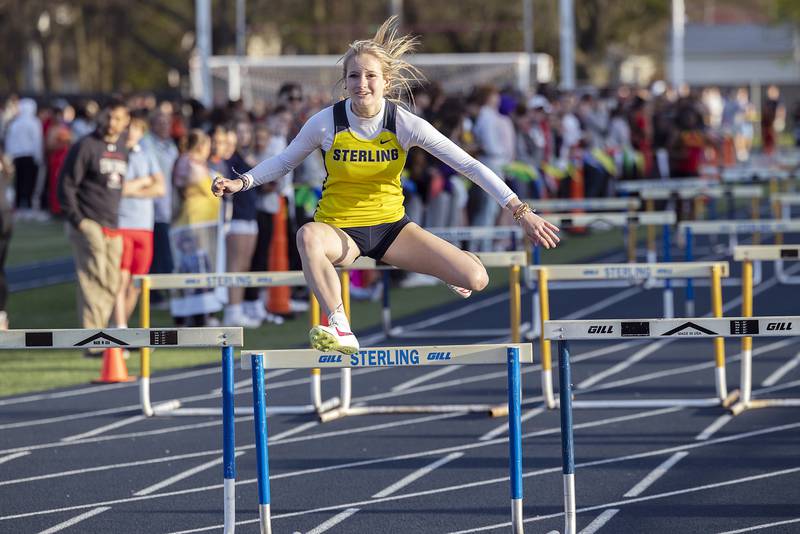 Sterling’s Anna Aulwes clears the last hurdle in the low hurdle shuttle Thursday, April 25, 2024 at the Sterling High School Night Relays.