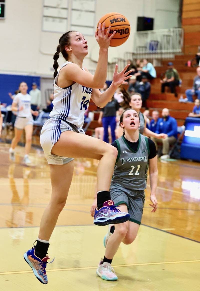 Princeton's Keighley Driscoll drives past Midland's Emma Franks Thursday night at Prouty Gym. The Tigresses won 69-34 to improve to 3-0 and advance to Saturday's championship game.